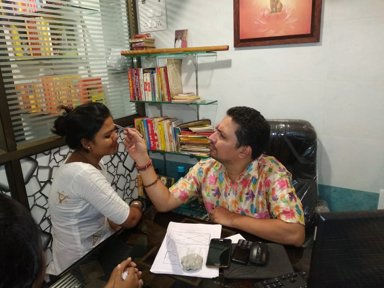A face-reading consultation at the clinic desk
