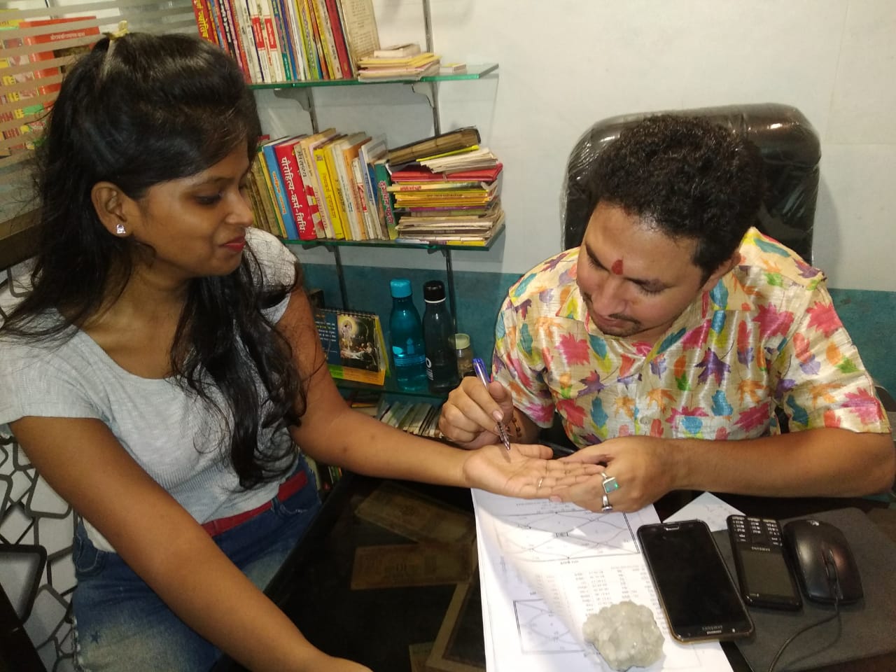 A palmistry consultation at Rudrashakti Astro Clinic