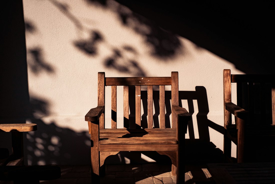 Two wooden chairs in a quiet, sunlit room